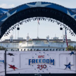 Large decorated stage with UFC Freedom 250 banners in front of the White House, featuring stars and patriotic colors.
