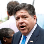 Illinois Gov. JB Pritzker looks on with his mouth open.