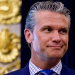 Secretary of War Pete Hegseth smiling