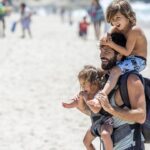 A dad and his two kids on the beach