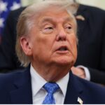 President Donald Trump seated