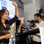 Democratic congressional candidate Melat Kiros with her fist raised