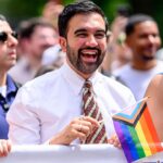 New York City Mayor Zohran Mamdani holding an LGBT flag
