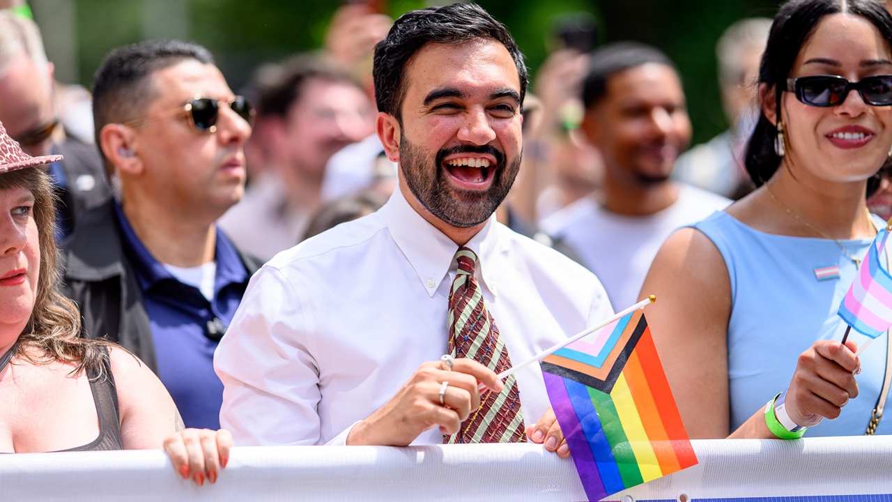 Home 4 New York City Mayor Zohran Mamdani holding an LGBT flag