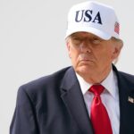 U.S. President Donald Trump wearing a hat that says "USA"