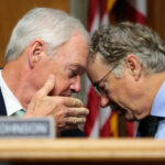 U.S. Sen. Ron Johnson (R-WI) speaks to Chairman Sen. Rand Paul (R-KY) during a business meeting with the Senate Homeland Security Committee