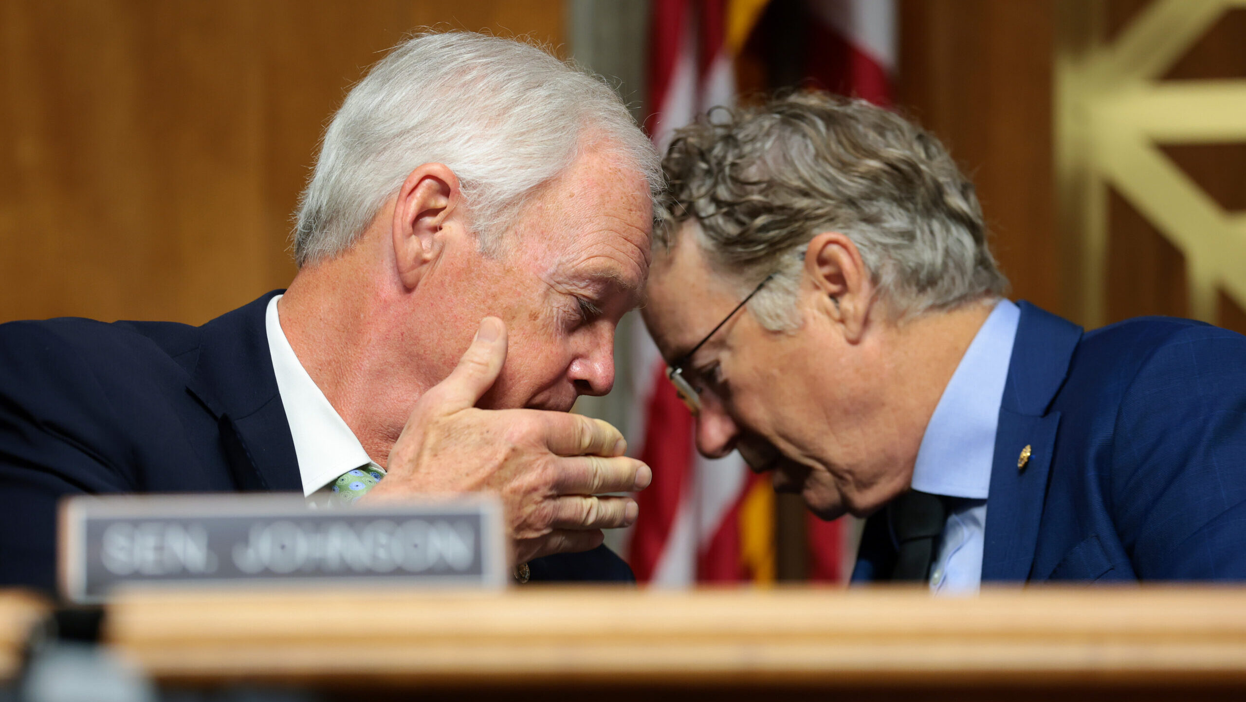 U.S. Sen. Ron Johnson (R-WI) speaks to Chairman Sen. Rand Paul (R-KY) during a business meeting with the Senate Homeland Security Committee