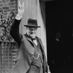 Winston Churchill holding up his hand in a "V" sign