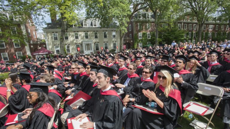 Harvard Business School graduates seated outdoors