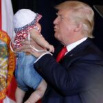 Donald Trump holding a baby