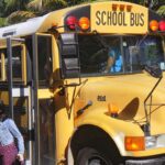 A girl getting off a school bus