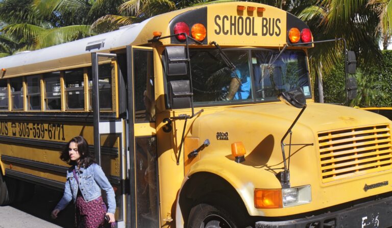 A girl getting off a school bus