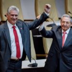 Former Cuban President Raul Castro raises the hand of current President Miguel Diaz-Canel