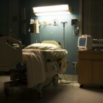 A bed in a darkened, empty hospital room.