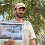 Survivor from the NOVA Music Festival massacre that happened on Oct. 7, 2023, shows a picture of his car, damaged by Hamas fire.
