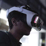 A man wears a virtual reality headset that contains the Headwall software.