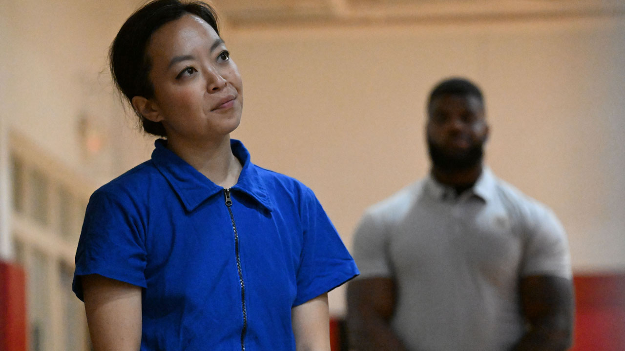 Wisconsin Gubernatorial candidate Francesca Hong (L) listen to Rep. Ilhan Omar (D-MN) speak before being introduced during a campaign rally.