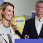 Governor Gavin Newsom looks on as his wife Jennifer Siebel Newsom speaks.