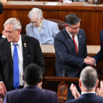 Representative Keith Self, Republican from Texas, and Representative Ralph Norman, Republican from South Carolina, look on as US Speaker of the House Mike Johnson, Republican from Louisiana, shakes hands with Representative Andy Ogles.