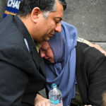 Two people cry during the memorial as hundreds of pro-Palestinian protesters gathered in Washington.