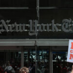 Members of the New York Times Guild gather for a rally outside of the New York Times building on May 20, 2026 in New York City.