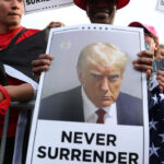 Hispanic Texas Voters Back Trump, Reject Sharia and Cornyn 3 A Trump supporter holds a photo of Donald Trump never surrender. (Spencer Platt/Getty Images)