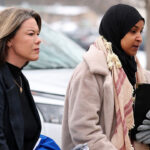 Ilhan Omar (D-MN) (R) and Angie Craig (D-MN) walk to the Bishop Henry Whipple Federal building.