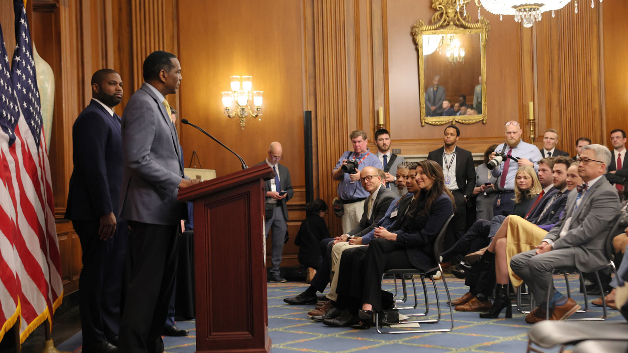 Rep. Burgess Owens (R-UT) speaks as Rep. Byron Donalds (R-FL) listens in the Rayburn Reception Room after formally unveiling the Frederick Douglass Press Gallery in the US Capitol.