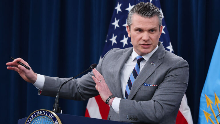 Secretary of War Pete Hegseth speaks to reporters in the Pentagon.
