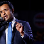 Vivek Ramaswamy gestures while up at a podium.