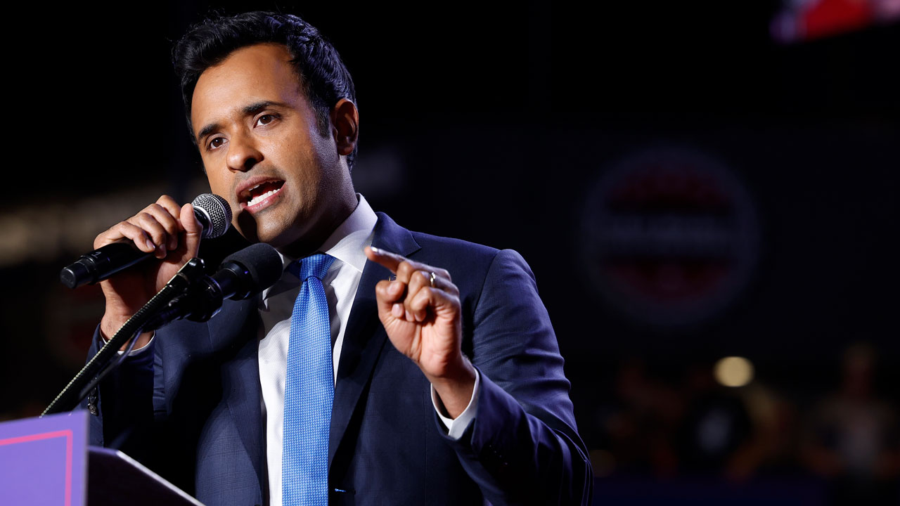 Vivek Ramaswamy gestures while up at a podium.
