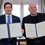 Secretary of State Marco Rubio (L) and Ultimate Fighting Championship CEO Dana White display a signed Memorandum of Understanding (MOU) during a ceremony at the U.S. State Department.
