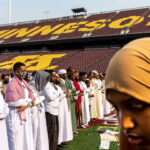 Muslim worshippers gather at the Huntington Bank Stadium during Eid al-Adha prayers and festivities.