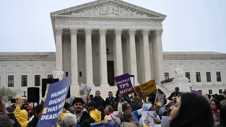 Members of the National TPS Alliance rally at the U.S. Supreme Court in Washington, D.C., on April 29. The Supreme Court is examining the revocation of Temporary Protected Status (TPS) for Haitian and Syrian migrants. (Photo by Alex WROBLEWSKI / AFP via Getty Images)