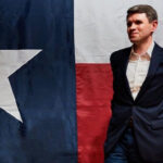 Talarico Distances Himself From 'Cringey' Comments Ahead of Midterms 3 Texas State Senator James Talarico strikes a pose in front of a Texas flag.