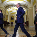 Sen. Majority Leader John Thune (R-SD) (C) departs after a meeting with U.S. President Donald Trump and Republican senators.