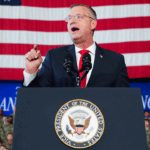 Secretary og Veterans Affairs Doug Collins speaks before Vice President JD Vance during an event marking 250 years of the American military at Naval Air Station Oceana in Virginia Beach, Virginia, on July 1, 2026. (Ken Cedeno/AFP via Getty Images)