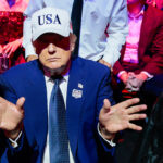 Donald Trump gestures to Melania Trump.