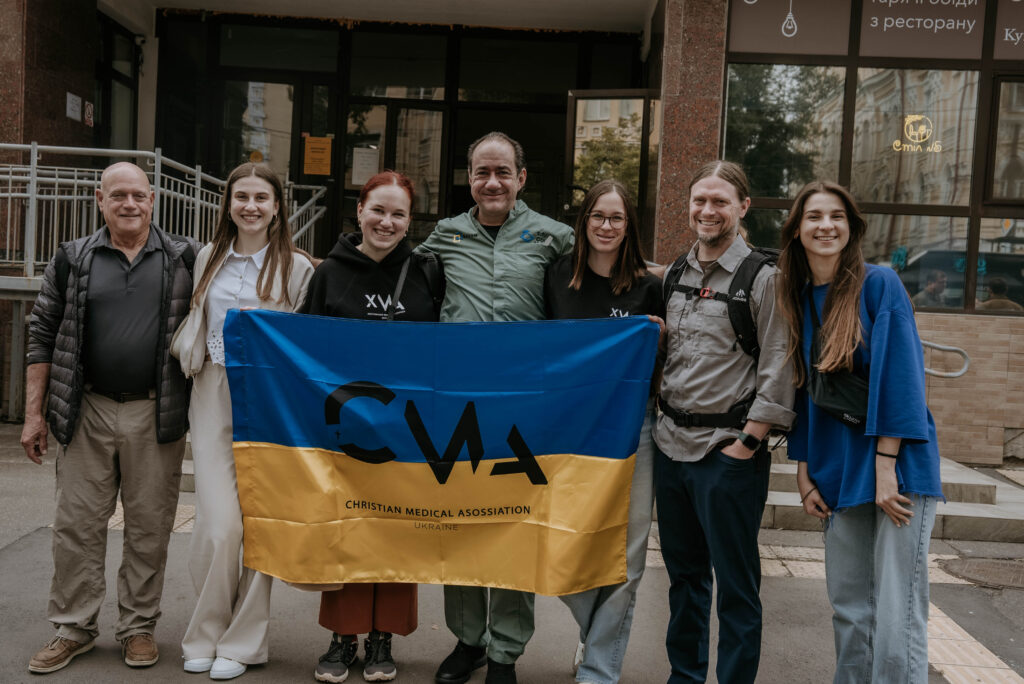 A group of people holding a CMA Ukraine banner