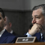 Hawley sits next to Cruz