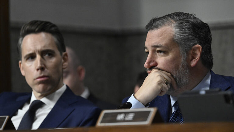 Hawley sits next to Cruz