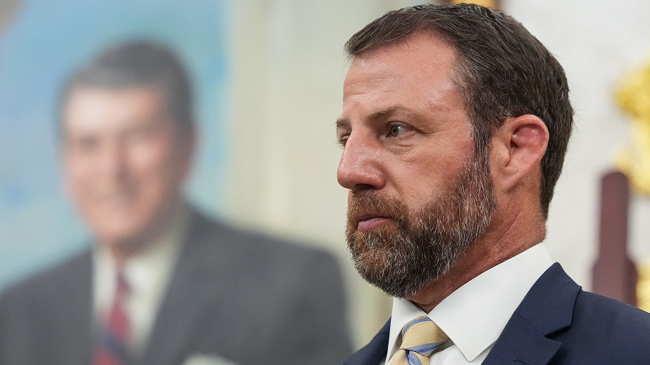 Marwayne Mullin looks on.