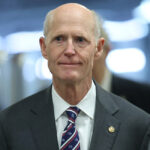 Rick Scott smiles