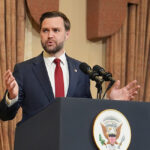 Vance talks at a podium
