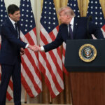 Kevin Warsh and Donald Trump shake hands